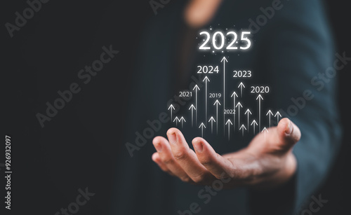 Businessman draws increase arrow graph corporate future growth year 2024 to 2025. Planning,opportunity, challenge and business strategy. New Goals, Plans and Visions for Next Year 2025.