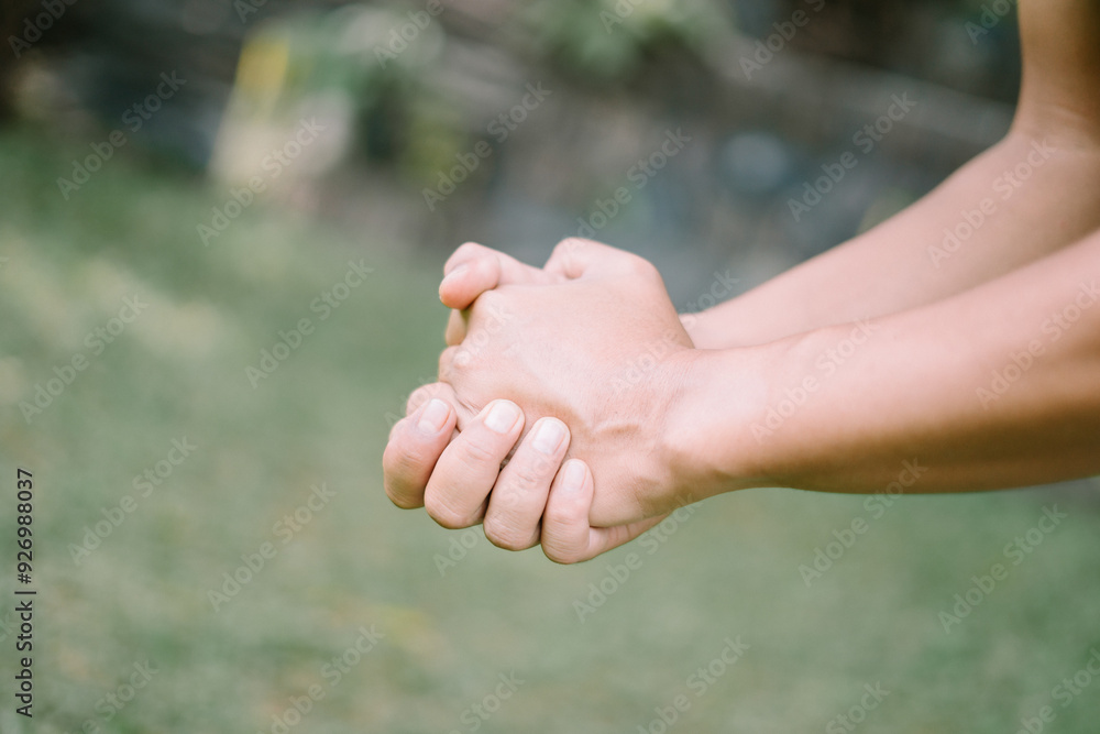 A close-up of a hand gripping its own wrist, capturing a moment of self-hold or contemplation, perfect for lifestyle A close-up of a hand gripping its own wrist, capturing a moment of self-hold or contemplation, perfect for lifestyle