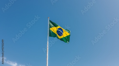 A vibrant Brazilian flag fluttering against a clear blue sky.