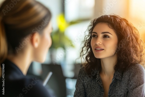 In the modern conference room, two attractive young female colleagues were engaged in a conversation.