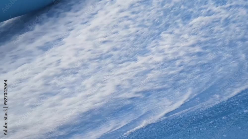 Young man surfing on a wave simulator at a water amusement park Young man surfing on a wave simulator at a water amusement park