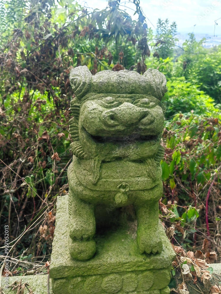 Close up of a lion stone statue in a park. Mythical creatures concept Close up of a lion stone statue in a park. Mythical creatures concept