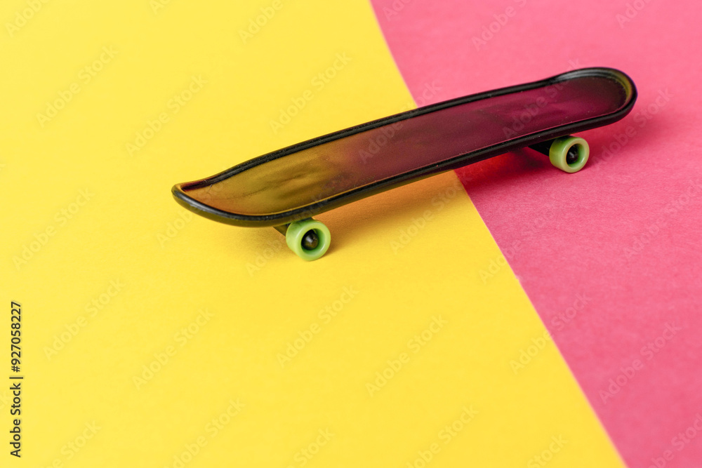 Minimalist Skateboard on Vibrant Yellow and Pink Background Minimalist Skateboard on Vibrant Yellow and Pink Background