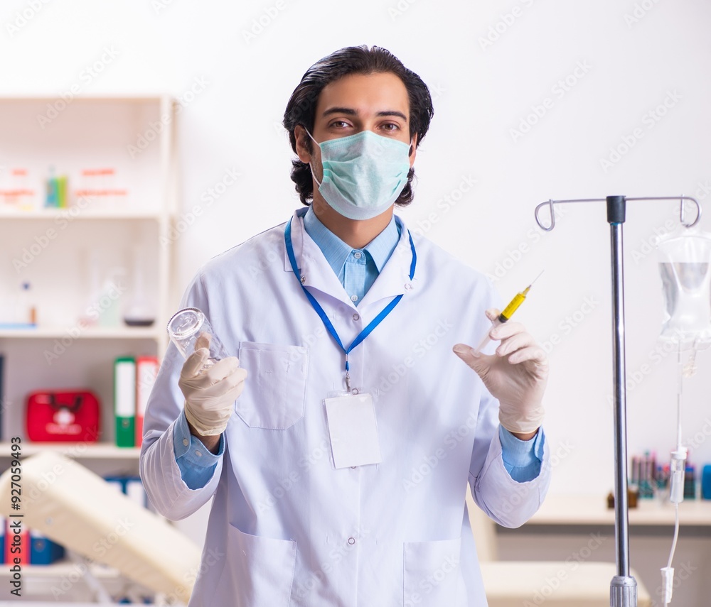 Young male doctor in blood transfusion concept Young male doctor in blood transfusion concept