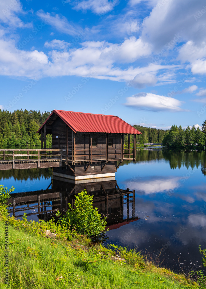 Obraz premium Small lake in woods. In the foreground rocks in water, trees. High quality photo. Fichtelsee, Bavaria, Germany