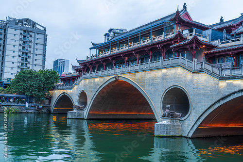 Famous landmark of Chengdu - Anshun bridge over Jin River illuminated at night, Chengdue, Sichuan , China photo