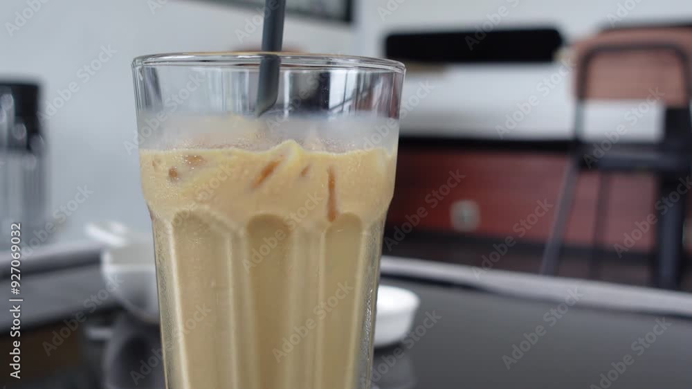 View of coffee in a transparent glass on a wooden tray