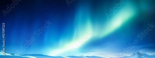  A photo of the night sky adorned with abundant green and blue auroras over snow-capped mountains
