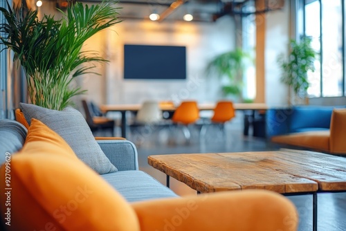 Modern Industrial Office Lounge: A contemporary office space features a cozy lounge area with a plush sofa, a rustic coffee table, and vibrant orange pillows, inviting relaxation and collaboration. Th