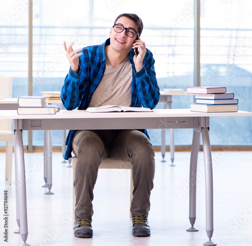 Student studying in the empty library with book preparing for ex photo