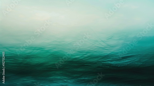 A calming, abstract image of a teal-colored water surface, with a foggy horizon in the distance. The water appears to be rippling and gently moving, creating a sense of tranquility and peace.