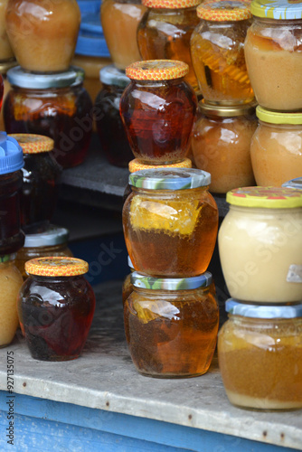Colourful glasses with honey in the self