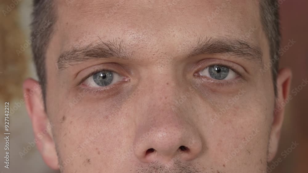 Gray male eyes close up. The man looks directly into the camera. Slow motion. High quality 4k footage Gray male eyes close up. The man looks directly into the camera. Slow motion. High quality 4k footage
