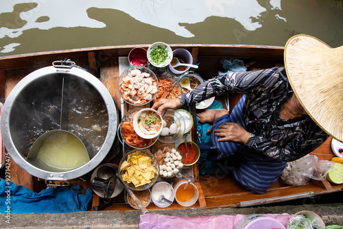 Photography top view thai asian old woman  Making noodles on the boat  in the local floating