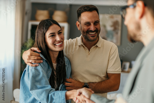 Quadro su tela Joyful millennial spouses share a handshake with their therapist at the psychoth