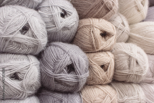Obraz na płótnie Grey and beige balls of yarn in storage. Warm wool yarn background. Knitting hobby. Row of grey and beige yarn. Handiwork store. Knit background. Handcraft concept. Knit pattern. w salonie