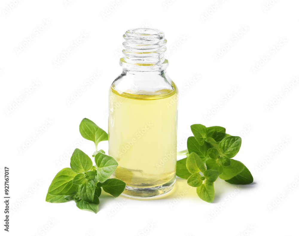 Essential oil in bottle and oregano leaves isolated on white Essential oil in bottle and oregano leaves isolated on white