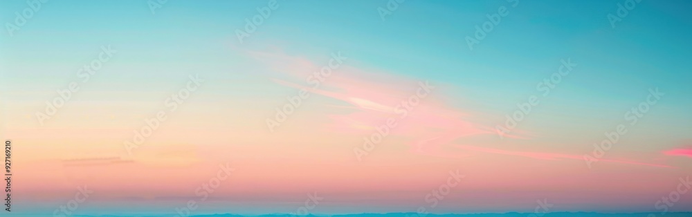 A soft, pastel pink and blue sky is visible at sunrise. There are thin, wispy clouds visible across the sky, with the pink hue becoming more prominent at the horizon. A soft, pastel pink and blue sky is visible at sunrise. There are thin, wispy clouds visible across the sky, with the pink hue becoming more prominent at the horizon.