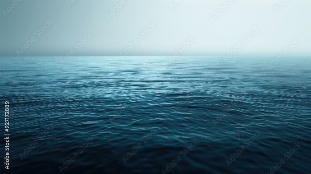 A wide shot of a calm blue ocean with gentle waves rippling across the surface. The horizon is obscured by a layer of mist, creating a serene and peaceful atmosphere. A wide shot of a calm blue ocean with gentle waves rippling across the surface. The horizon is obscured by a layer of mist, creating a serene and peaceful atmosphere.