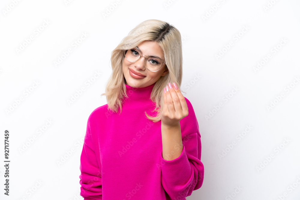 Young Russian woman isolated on white background making money gesture Young Russian woman isolated on white background making money gesture