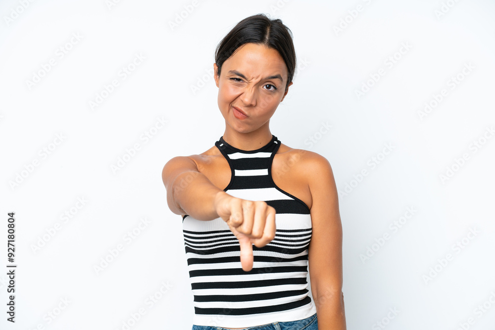 Young hispanic woman isolated on white background showing thumb down with negative expression Young hispanic woman isolated on white background showing thumb down with negative expression