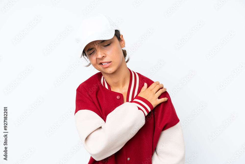 Young hispanic woman wearing a baseball uniform isolated on white background suffering from pain in shoulder for having made an effort Young hispanic woman wearing a baseball uniform isolated on white background suffering from pain in shoulder for having made an effort