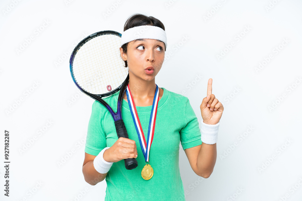 Young tennis player woman isolated on white background thinking an idea pointing the finger up