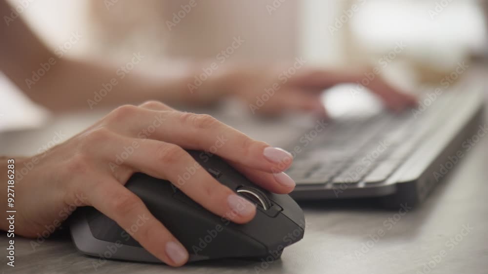 Close-up of hands using a mouse and typing on a keyboard Close-up of hands using a mouse and typing on a keyboard