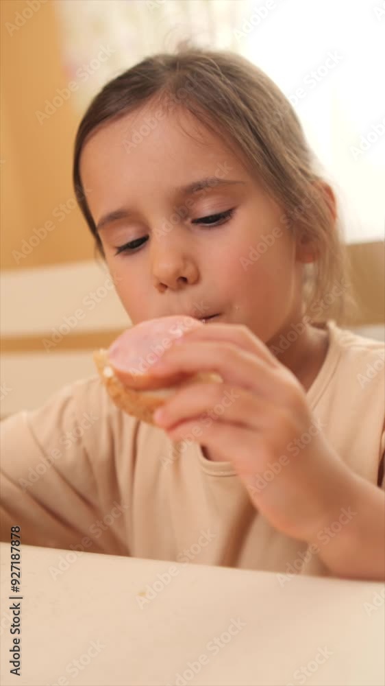 vertical video Young girl savoring a sandwich at home in different steps vertical video Young girl savoring a sandwich at home in different steps