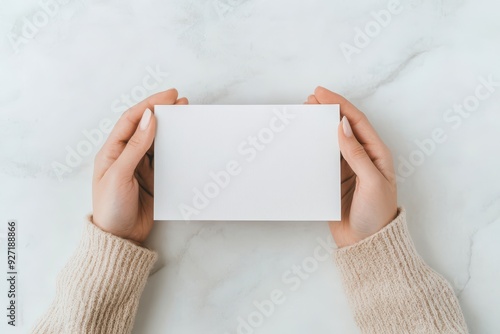 Blank Greeting Card Presentation, individual showcasing an empty greeting card against a clean white backdrop, ideal for design mockups or personalized message ideas photo