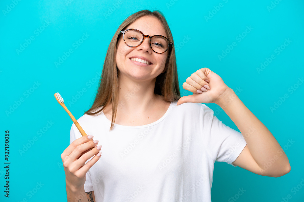 Young Lithuanian woman brushing teeth over isolated background proud and self-satisfied Young Lithuanian woman brushing teeth over isolated background proud and self-satisfied