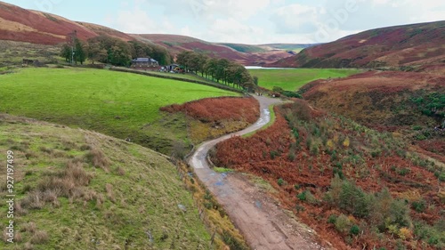 Rural country single track road in the Yorkshire moors. UK country landscape with heather covered moorlands and hiking trail. photo