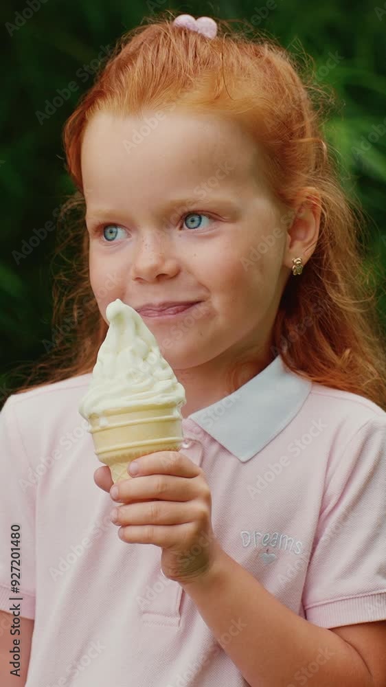 Little girl enjoying ice cream cone in a park on a sunny day Little girl enjoying ice cream cone in a park on a sunny day