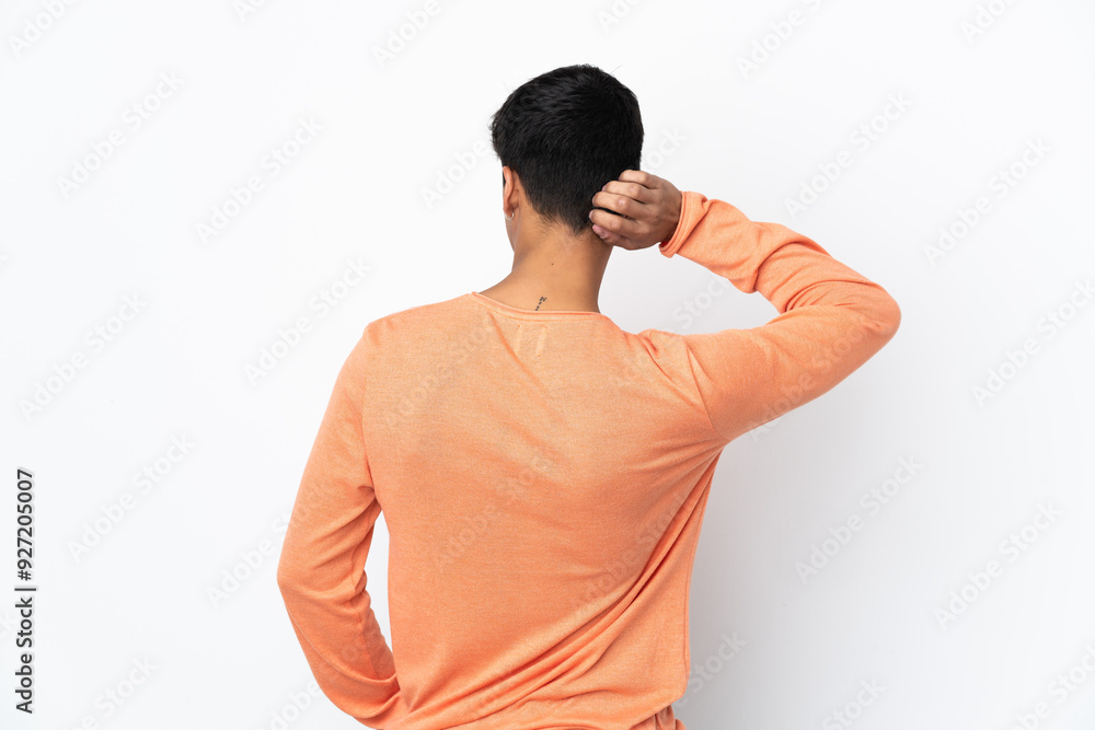 Young man over isolated white background in back position and thinking Young man over isolated white background in back position and thinking