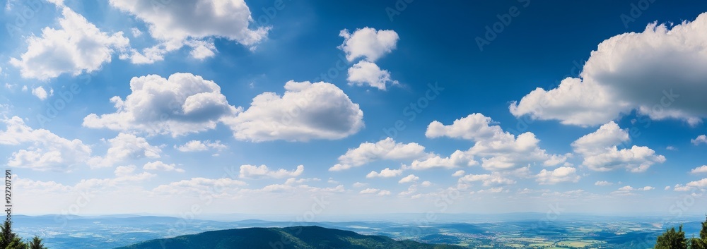 Obraz premium Panoramic view of a blue sky with white clouds, featuring photorealistic, high-resolution landscapes with soft shadows, natural tones, and clean, sharp focus.