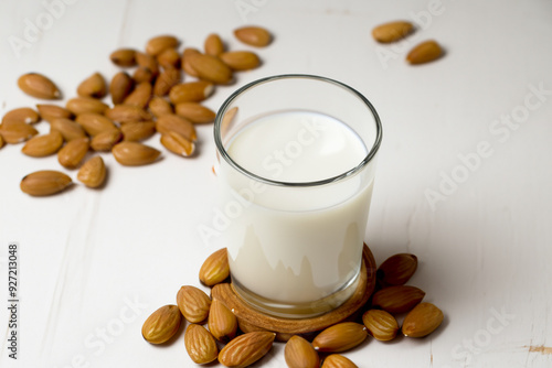 Almonds with whites and milk on a. Water food nature concept. A man drinking milk with almonds and nuts on a white . A white with almonds, nuts, lifestyle and milk. photo