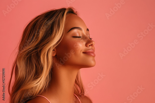 A close up of a woman's face with her eyes closed and long blond hair