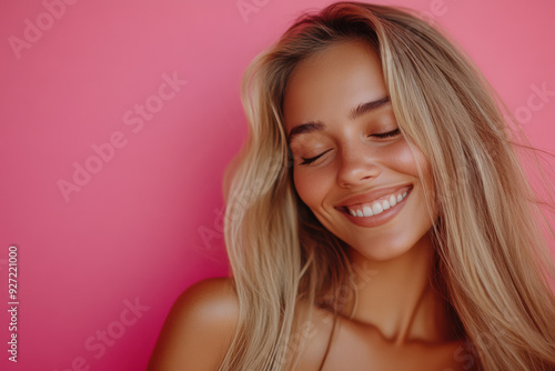 A close up of a woman's face with her eyes closed and long blond hair