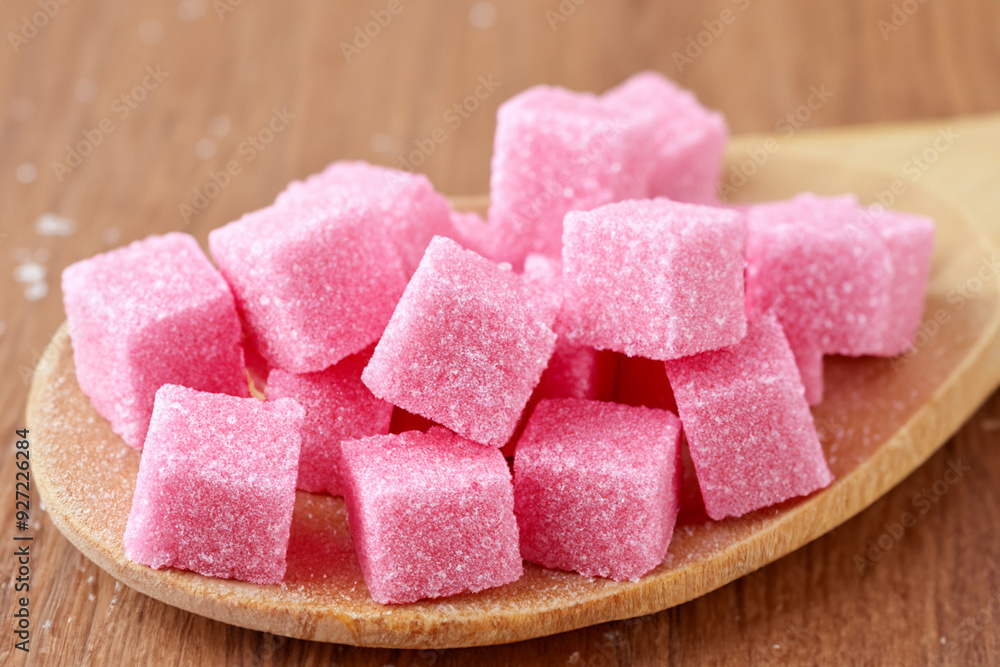 A wooden spoon with cubes of sugar on it. White cane brown concept. A spoon with pink and white sugar on it and cubes on it. A wooden spoon with cubes of sugar on lifestyle it. A wooden spoon with cubes of sugar on it. White cane brown concept. A spoon with pink and white sugar on it and cubes on it. A wooden spoon with cubes of sugar on lifestyle it.