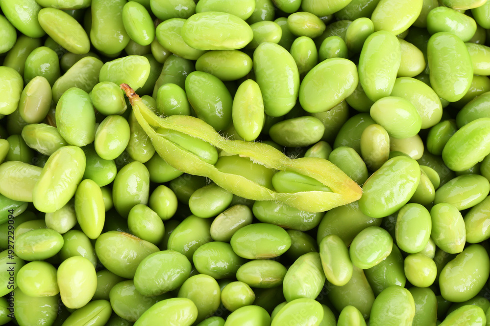 Raw green edamame pod on soybeans as background, top view Raw green edamame pod on soybeans as background, top view