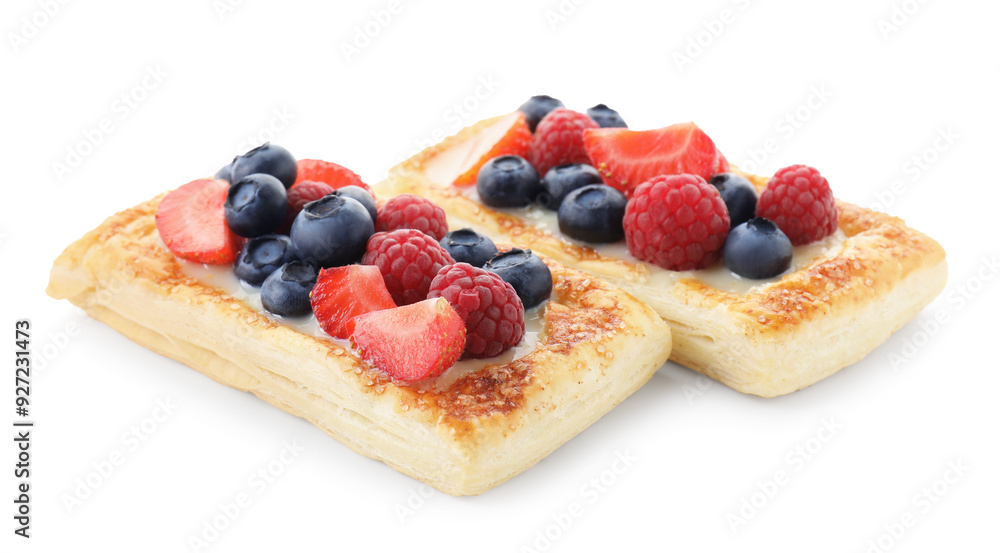 Tasty puff pastries with berries isolated on white Tasty puff pastries with berries isolated on white