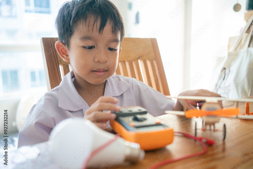 Little school boy assembly airplane roboy toy in class Little school boy assembly airplane roboy toy in class