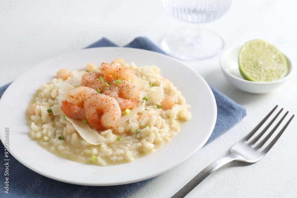 Delicious risotto with shrimps and cheese on white table, closeup Delicious risotto with shrimps and cheese on white table, closeup