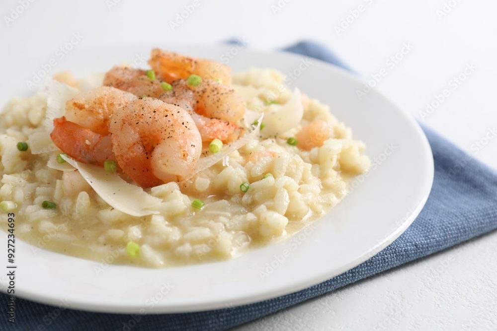 Delicious risotto with shrimps and cheese on white table, closeup Delicious risotto with shrimps and cheese on white table, closeup
