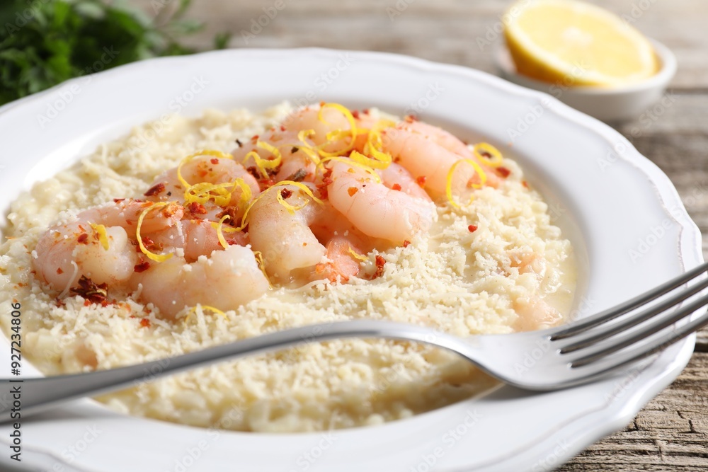 Delicious risotto with shrimps and cheese on wooden table, closeup Delicious risotto with shrimps and cheese on wooden table, closeup