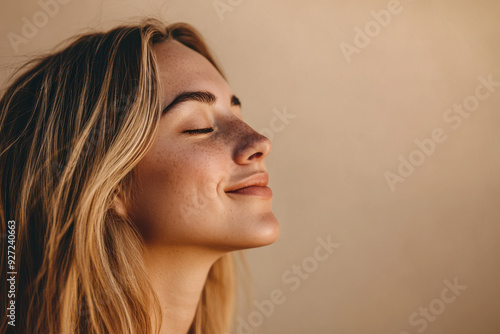 A close up of a woman's face with her eyes closed and long blond hair