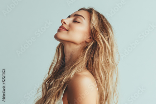 A close up of a woman's face with her eyes closed and long blond hair