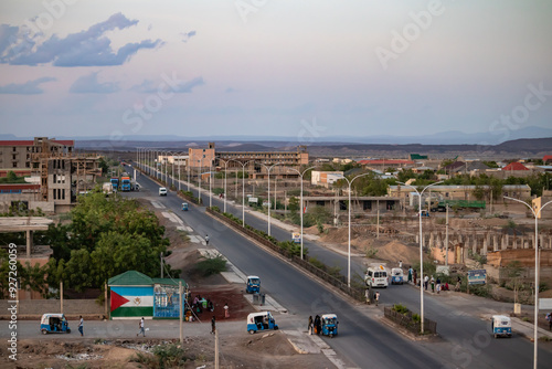 A view of Semera city's main street highway in Ethiopia shows traffic moving around, capturing the bustling urban environment and daily life