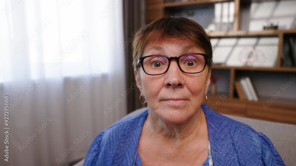 An elderly woman initially looks to side, then turns toward the camera with surprised expression. Close up of female stares directly into the camera, displaying mixture of shock and amazement. An elderly woman initially looks to side, then turns toward the camera with surprised expression. Close up of female stares directly into the camera, displaying mixture of shock and amazement.