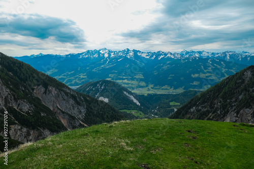 Scenic aerial view of majestic alpine landscape with snow-capped mountain ridges of Schladminger Tauern in Ramsau am Dachstein, Styria, Austria. Hiking trail through alpine greenery in Austrian Alps photo